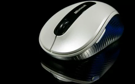 Close-up of a sleek Microsoft mouse against a black background, featured as an HD PC desktop wallpaper highlighting technology.