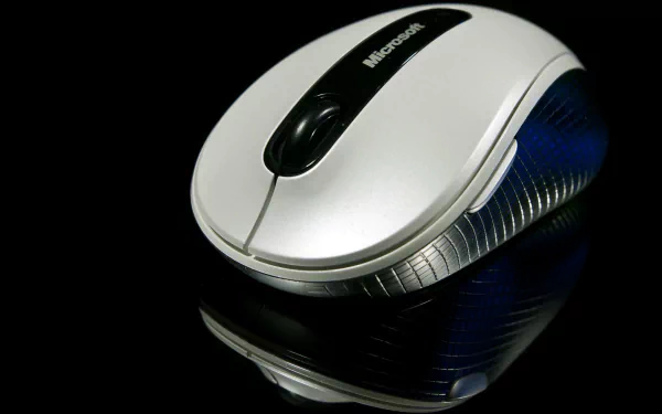 Close-up of a sleek Microsoft mouse against a black background, featured as an HD PC desktop wallpaper highlighting technology.