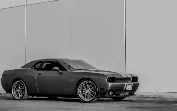 Black Dodge Challenger SRT8 parked against a plain wall, captured in high-definition for a sleek PC desktop wallpaper and background.