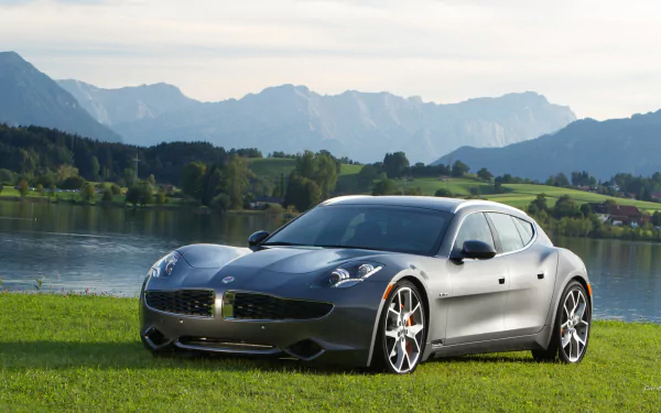 Vehicle Fisker Surf parked on a grassy lakeshore with distant mountains and calm water, presented as an HD PC desktop wallpaper and background.