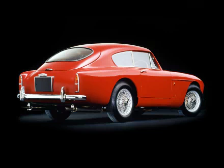 Red Aston Martin DB Mark III classic vehicle, rear three-quarter view on a black backdrop — HD PC desktop wallpaper and background.