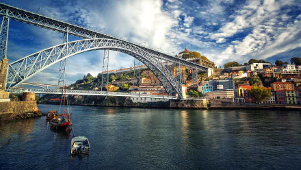 The Dom Luís I Bridge in Porto, Portugal, spans the Douro River under a dynamic sky in this vivid 4K Ultra HD desktop wallpaper.