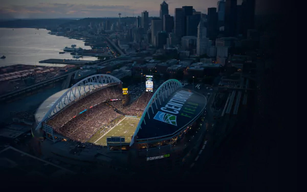 Aerial view of Seattle Seahawks Stadium at dusk, with the lit-up field and surrounding cityscape of Seattle, captured in HD for a vibrant desktop wallpaper background.