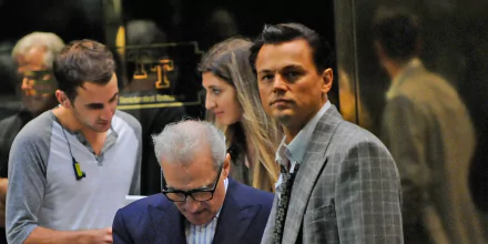 HD desktop wallpaper from The Wolf of Wall Street featuring Leonardo DiCaprio as Jordan Belfort and director Martin Scorsese.