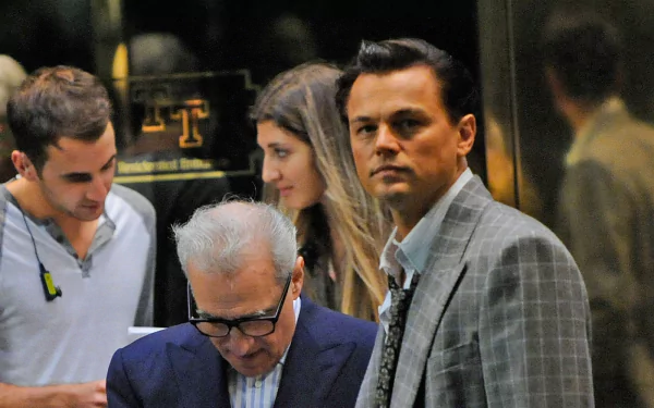 HD desktop wallpaper from The Wolf of Wall Street featuring Leonardo DiCaprio as Jordan Belfort and director Martin Scorsese.