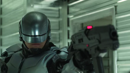 HD PC desktop wallpaper featuring RoboCop from the 2014 RoboCop movie, showing the armored character aiming a futuristic handgun in a metallic corridor.