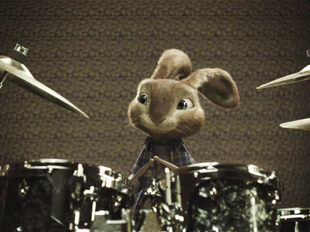 Easter Bunny (Hop) plays a drum kit, smiling in a music room — 2K Quad HD PC desktop wallpaper/background.