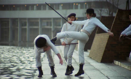 HD desktop wallpaper from the movie A Clockwork Orange, featuring characters dressed in white performing a dynamic dance near a waterfront.