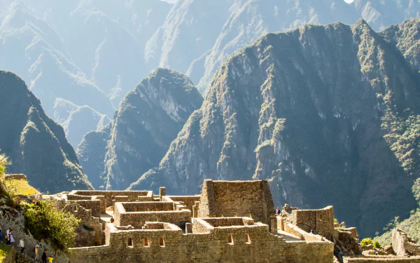 4K Ultra HD desktop wallpaper showcasing the man-made ancient stone structures of Machu Picchu set against a backdrop of towering mountain peaks.