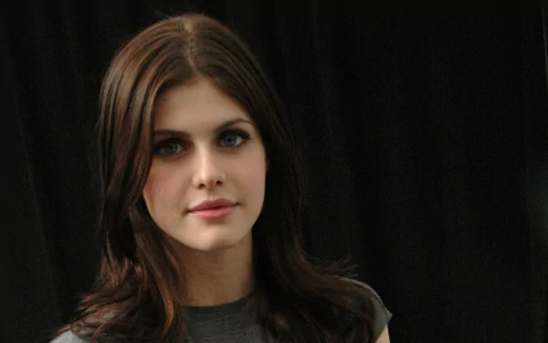 HD desktop wallpaper featuring Alexandra Daddario against a dark background, wearing a casual grey top with a serene expression.