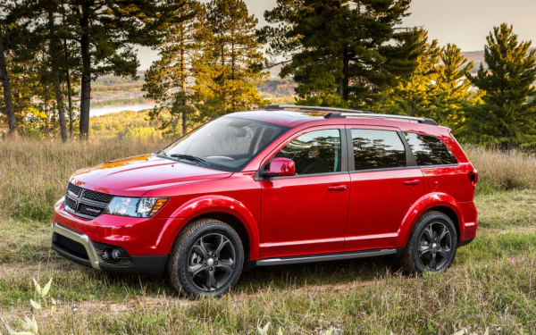 A red Dodge Journey parked on grass with trees and a scenic background, captured as an HD PC desktop wallpaper and background.