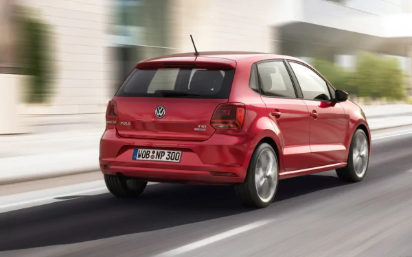 HD PC desktop wallpaper featuring a red Volkswagen Polo driving on a city street, showcasing the vehicle's sleek rear design and dynamic motion.