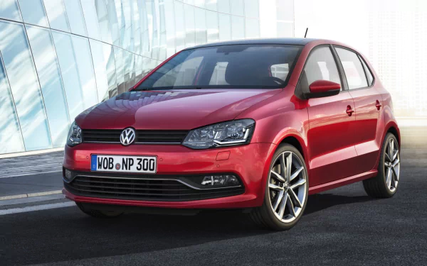 HD PC desktop wallpaper featuring a red Volkswagen Polo parked in front of a modern glass building, highlighting the vehicle's sleek design and sporty wheels.