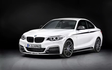 HD desktop wallpaper featuring a white BMW 2 Series vehicle against a dark background, highlighting its sleek design and sporty details.