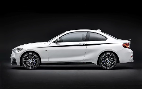 White BMW 2 Series coupe side profile on a dark studio backdrop — BMW vehicle 2K Quad HD PC desktop wallpaper and background.