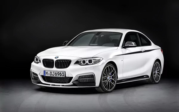 HD desktop wallpaper featuring a white BMW 2 Series vehicle against a dark background, highlighting its sleek design and sporty details.