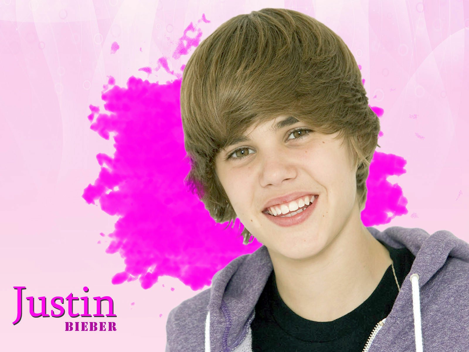HD desktop wallpaper of a young Justin Bieber smiling in front of a pink splatter background. The name Justin is written in purple text. Tags: music, Justin Bieber.