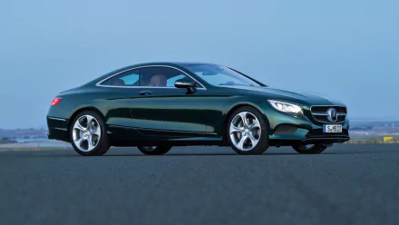 Green Mercedes-Benz S-Class Coupe on open tarmac, sleek luxury vehicle profile — HD PC desktop wallpaper and background showcasing Mercedes-Benz S-Class styling.