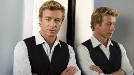 HD PC desktop wallpaper featuring Simon Baker as Patrick Jane from the TV show The Mentalist, with his reflection visible in a mirror behind him.