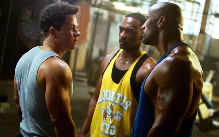 Mark Wahlberg, Anthony Mackie, and Dwayne Johnson in a scene from the movie Pain & Gain. This HD wallpaper captures the intense camaraderie and action in the film.