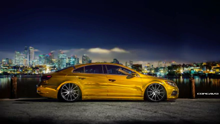 A sleek gold Volkswagen CC parked by a waterfront with a city skyline at night, captured in stunning 4K Ultra HD for PC desktop wallpaper and background.