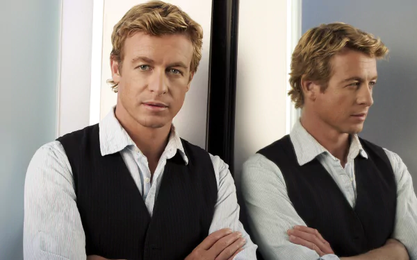 HD PC desktop wallpaper featuring Simon Baker as Patrick Jane from the TV show The Mentalist, with his reflection visible in a mirror behind him.
