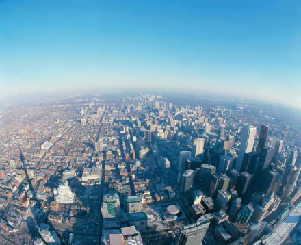 HD PC desktop wallpaper: aerial view of Toronto's man-made cityscape, sweeping downtown skyline and towers beneath a clear blue sky.