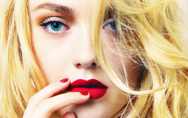 A striking HD wallpaper featuring Dakota Fanning, an American actress, showcasing her captivating blue eyes and bold red lips against a backdrop of flowing blonde hair.