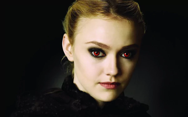 A striking HD desktop wallpaper featuring American actress Dakota Fanning, showcasing her intense gaze with dramatic makeup and a dark backdrop.