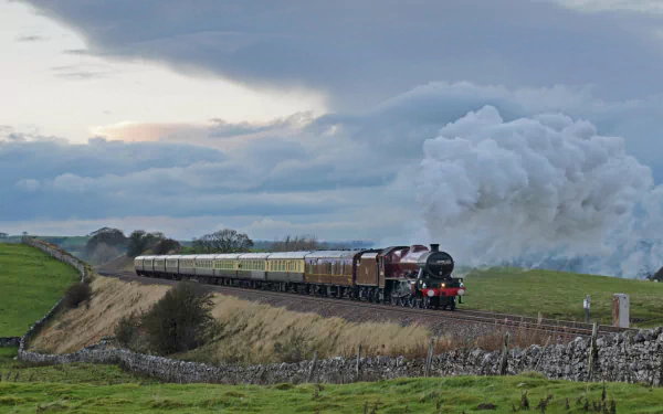 HD desktop wallpaper featuring a classic steam train traveling through a scenic countryside under a cloudy sky.