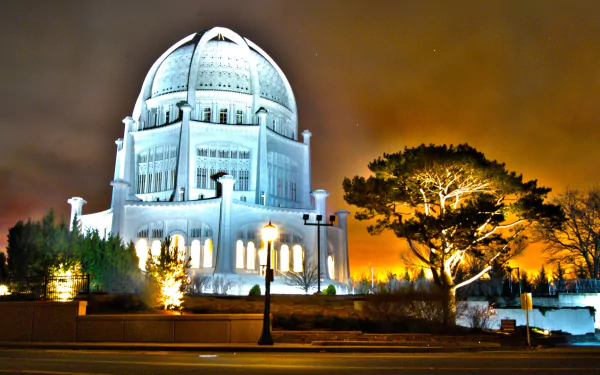 HD desktop wallpaper featuring the illuminated Baha'i Temple at night, showcasing its religious architecture against a dramatic sky.