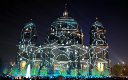 Artistic Festival of Lights - Berlin: illuminated cathedral façade with swirling blue-white light patterns, fountains and crowd at night; HD PC desktop wallpaper/background.