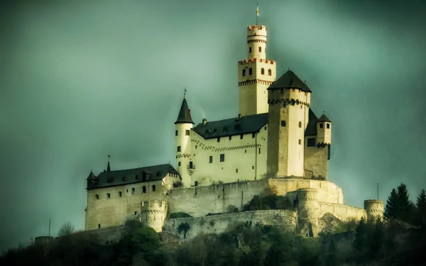 HD desktop wallpaper showcasing the historic man-made Marksburg Castle perched atop a hill under a moody sky.
