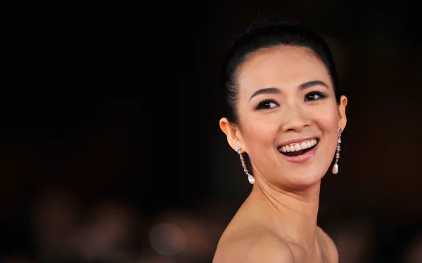 Close-up of Chinese actress and celebrity Zhang Ziyi smiling against a dark background, captured in 4K Ultra HD quality for a PC desktop wallpaper.