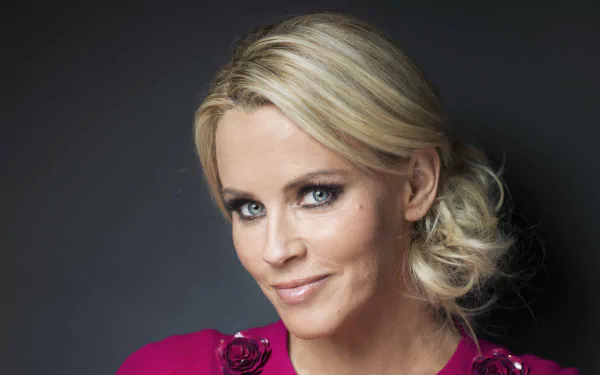 Close-up portrait of American model and celebrity Jenny McCarthy with blonde hair and blue eyes, featured in a 4K Ultra HD PC desktop wallpaper background.