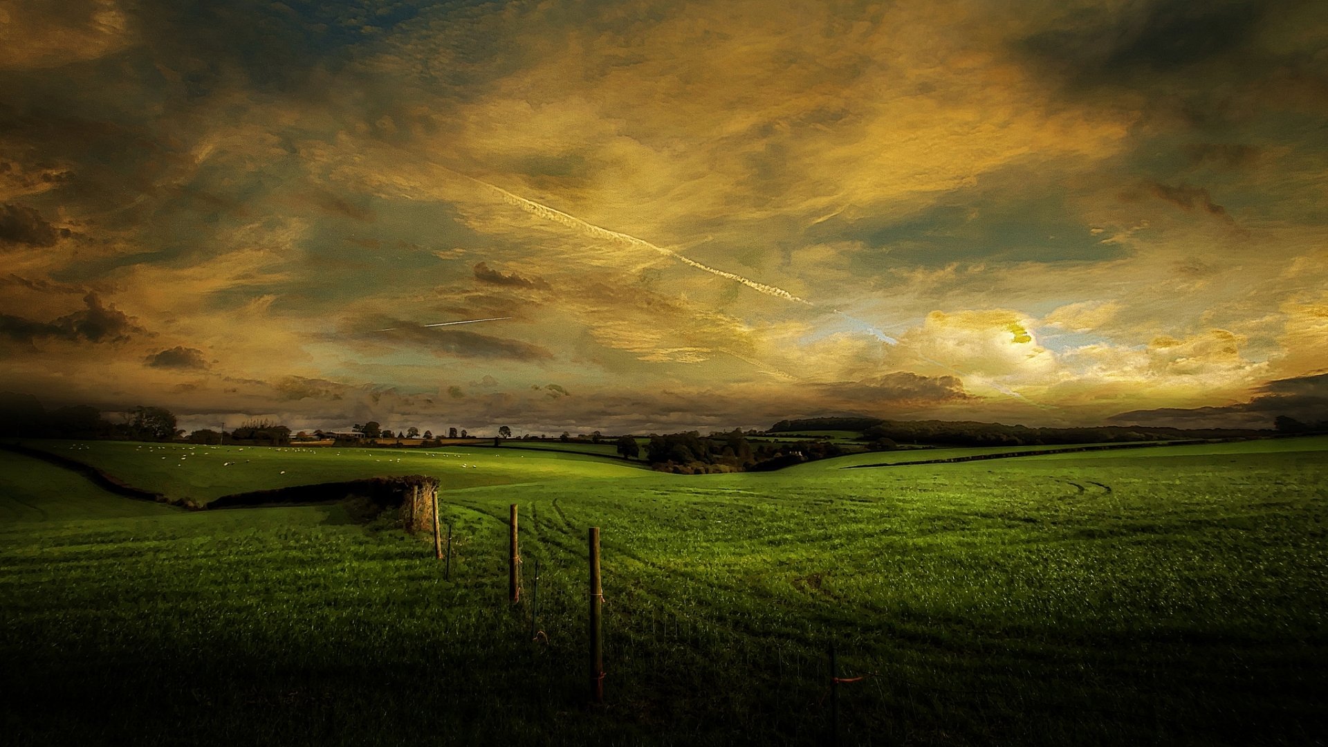 A serene landscape featuring lush green fields under a dramatic sky, showcasing the beauty of nature. This HD image makes a striking desktop wallpaper and background.