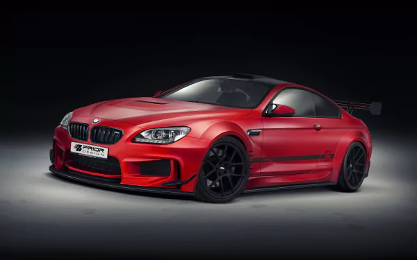 HD desktop wallpaper featuring a red Prior Design BMW M6 with sleek lines and black wheels against a dark background.