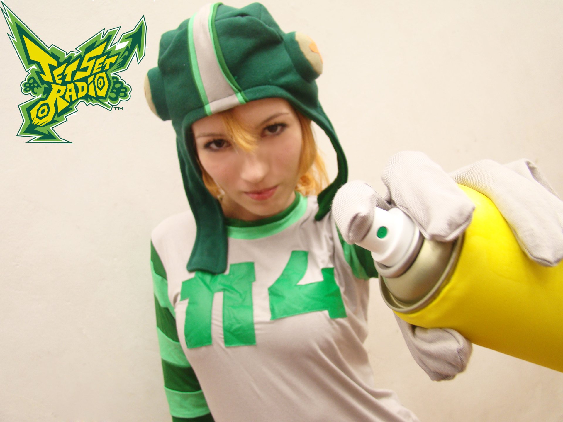 HD desktop wallpaper featuring a woman cosplaying as a Jet Set Radio character, holding a spray paint can with the game's logo in the corner.