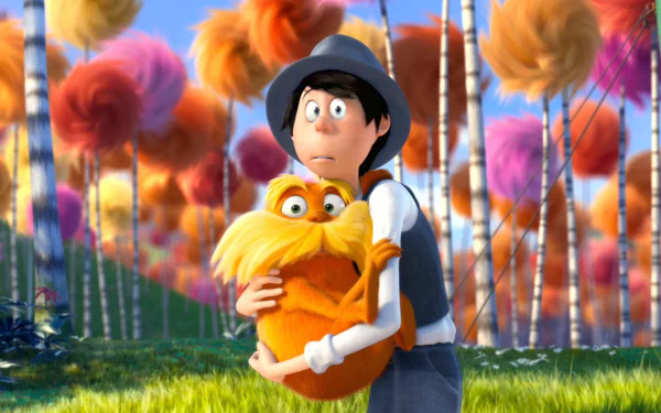 HD PC desktop wallpaper of the Once-ler from the movie The Lorax hugging the orange mustached Lorax among colorful Truffula trees.