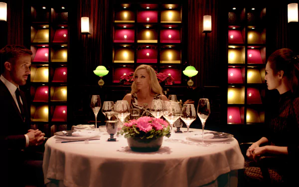 4K Ultra HD wallpaper featuring Kristin Scott Thomas, Ryan Gosling, and a scene from the movie Only God Forgives with a tense dinner table setting.