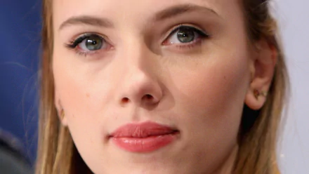 A high-definition desktop wallpaper featuring a close-up of Scarlett Johansson, showcasing her expressive eyes and subtle makeup against a blurred background.