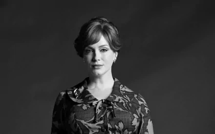 Black and white HD desktop wallpaper featuring American actress and celebrity Christina Hendricks with a calm expression against a dark background.