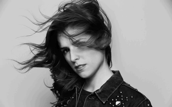 A striking black-and-white portrait of American actress Anna Kendrick, featuring her dynamic hairstyle and confident expression, makes for an engaging HD desktop wallpaper.