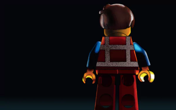HD PC desktop wallpaper of Emmet from The Lego Movie: a LEGO minifigure in a construction vest, shown from behind under a spotlight on a dark background.