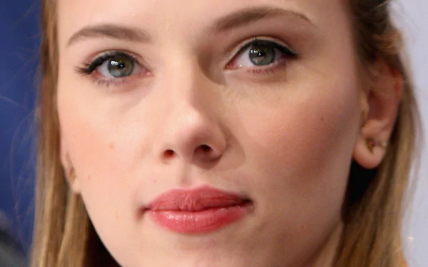 A high-definition desktop wallpaper featuring a close-up of Scarlett Johansson, showcasing her expressive eyes and subtle makeup against a blurred background.