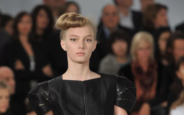 French model Sigrid Agren walks the runway in a black outfit, captured in a high-definition PC desktop wallpaper and background image.