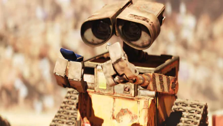 A vibrant HD wallpaper featuring Wall·E, the beloved robot character from the movie, showcasing his inquisitive nature as he holds a small object in his hands.