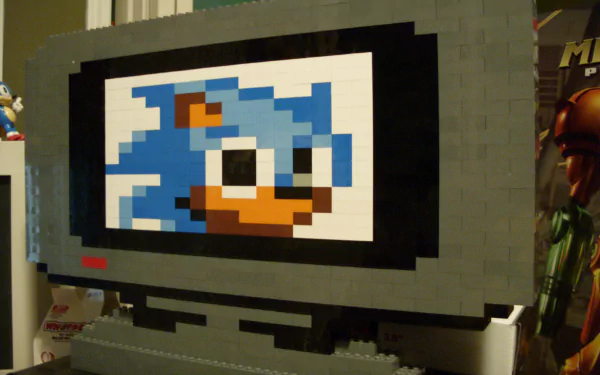 HD PC desktop wallpaper featuring a man-made LEGO sculpture of Sonic the Hedgehog displayed on a blocky screen.