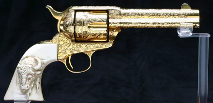 HD desktop wallpaper featuring a detailed, ornate man-made revolver with gold engravings and a white handle against a dark background.