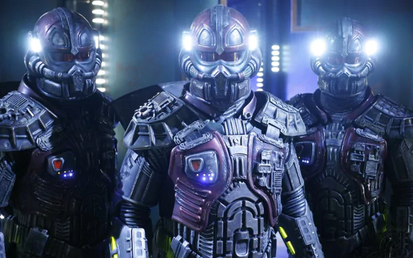 Three armored Jaffa warriors from the TV show Stargate SG-1 with glowing helmets and chest lights, shown as a 2K Quad HD PC desktop wallpaper/background.